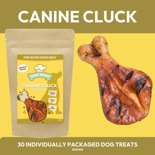 A stand-up pouch of Chef Woof Canine Cluck dog treats next to a single grilled bone-shaped treat on a yellow background with olive-green text banners reading CANINE CLUCK and 30 individually packaged dog treats.